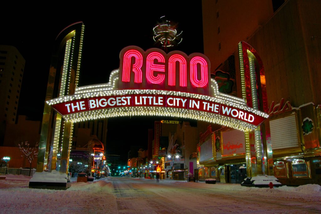 Reno's The Biggest Little City In The World sign with snow on road.